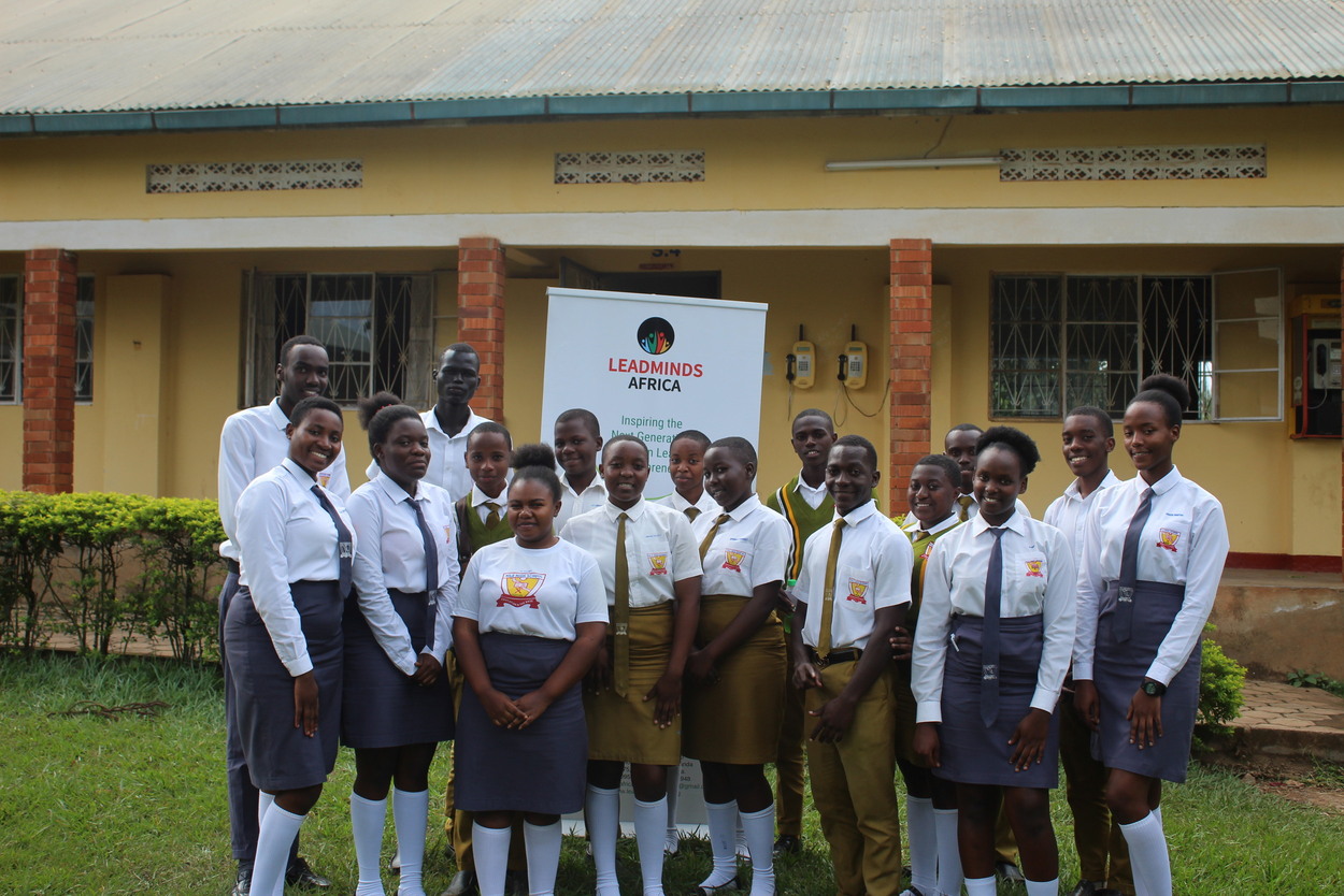A group of students in uniform posing in the courtyard.