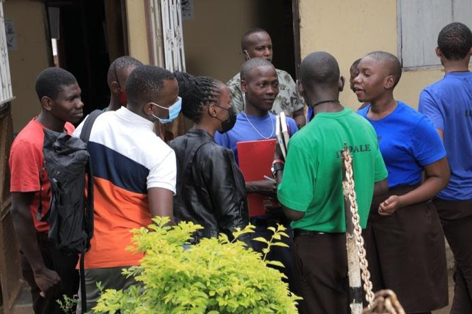 A candid shot of a group of LeadMinds Africa students in a focused discussion after a seminar.