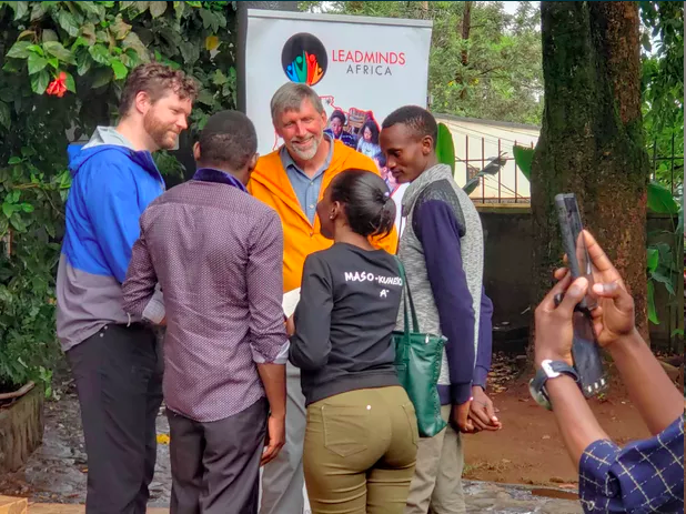 Visitors from the United States talking with a group of LeadMinds Africa students.