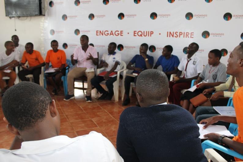 Students engaging in a guided discussion in a circle.