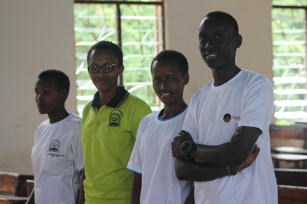 A group of students standing in a line and smiling.