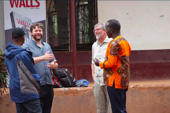 Conference presenters laughing with some LeadMinds Africa students.